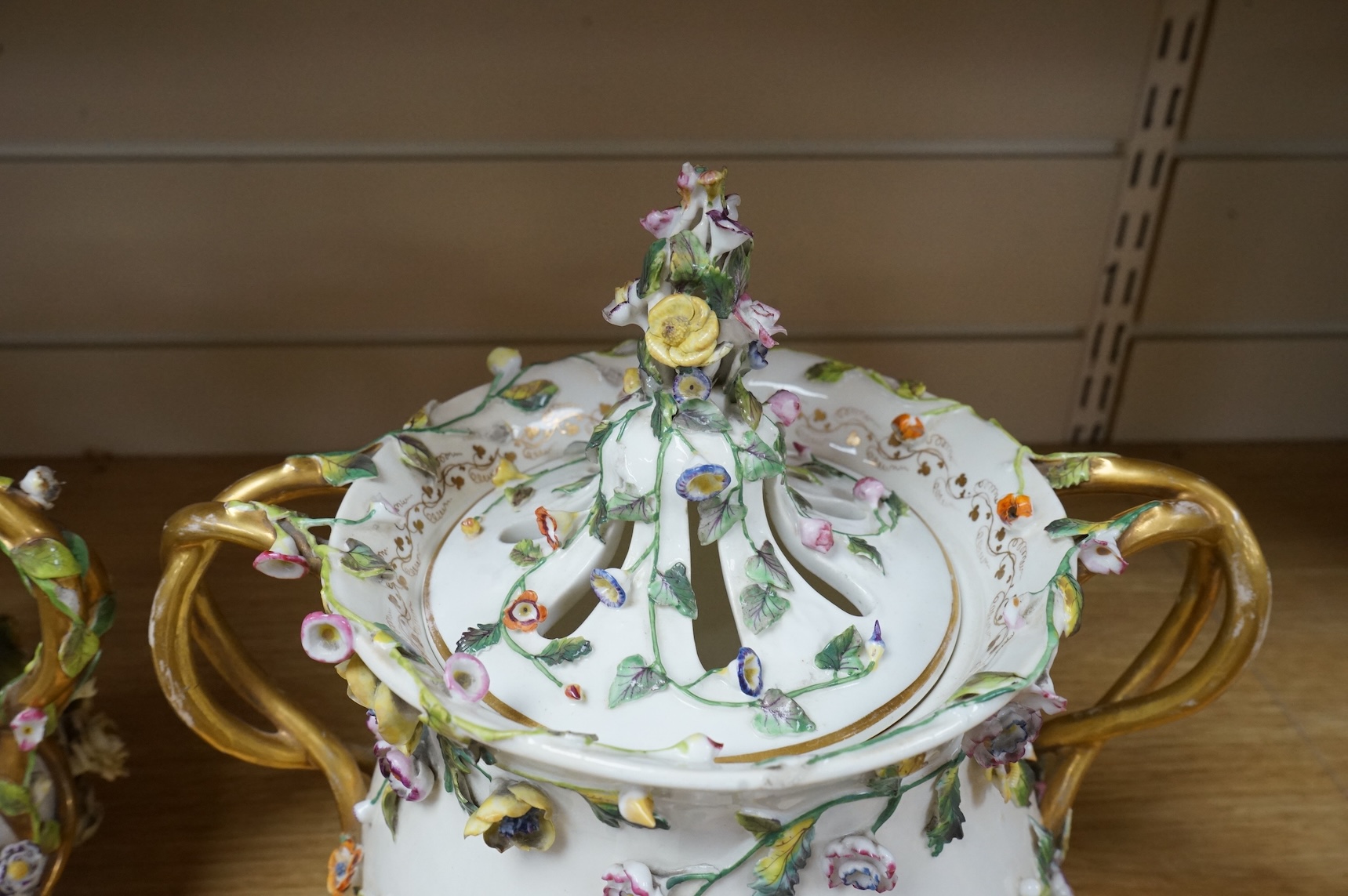A pair of Rockingham two handled pot pourri vases and covers, c.1830-42, the first painted with two named views near Lyme, Dorsetshire and Stockly Bridge’, The second with an unnamed view of a monument by a lake, the rev